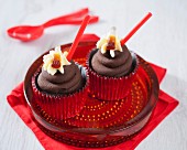 Chocolate cupcakes with cola and cola bottle sweets