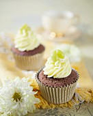 Chocolate cupcakes with vanilla frosting and green apple bonbons