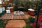 Fireplace on raised terrace made from recycled wooden pallets