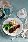 Salmon with a pepper crust, mange tout and a baked potato