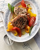 Grilled saddle of pork with a wild herb marinade on a warm pepper salad