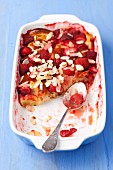 Bread pudding with strawberries and flaked almonds