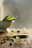 Peas and pea pods on a wooden table
