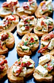 Bruschetta with feta cheese, dried tomatoes and herbs