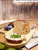 Pumpkin seed bread, sliced, on a rustic garden table