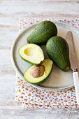 Fresh avocados, whole and halved