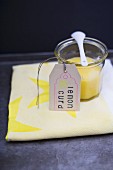 Lemon curd in a jar with a paper tag