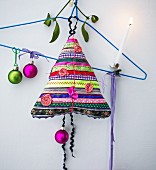 Hand-made Christmas-tree-shaped cushion made from colourful strips of fabric