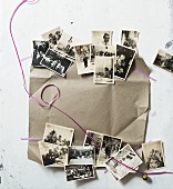 Festive arrangement of old black and white family photos, ribbon and wrapping paper