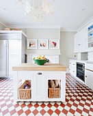 Island counter on red and white chequered floor in spacious kitchen