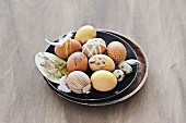 Easter eggs painted using natural dyes & decorated with ribbons & feathers