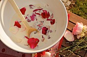 Milk and petals in bowl for making milk-based beauty treatment