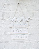 Romantic, white, shabby-chic metal sign decorated with bird figurines hung on wall