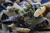 White a asparagus with black morel mushrooms, black pasta, thyme and a creamy sauce