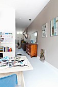 View of antique chest of drawers in hallway seen from modern study