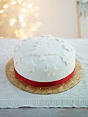 A festive Christmas Cake decorated with white fondant icing