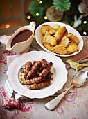 Pigs in blankets with fried potatoes and gravy
