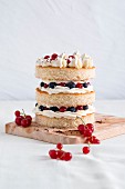 A sponge cake tower with fresh berries and butter cream