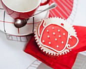 A cupcake decorated with a teapot