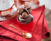 A cupcake decorated with chocolate sweets