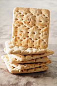 A stack of crackers with one standing on edge