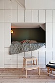 Floor-to-ceiling fitted cupboards and cubby bed in child's bedroom