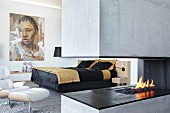 Concrete gas fireplace in modern bedroom