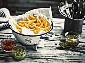Chips in a colander lined with kitchen paper