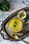 Mango and passion fruit drink with mint on a silver tray
