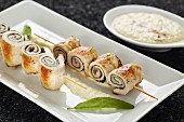 Stuffed pork roll skewers with pear mousse