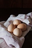 Four brown chicken's egg on a cloth