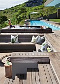 Pool complex on slope with sunken seating area in wooden deck and small, children's pool