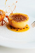 Peach with caramel and passion fruit sauce