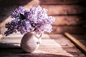 Bouquet of lilac against wooden background