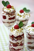 Layered desserts with creamy yoghurt, raspberries and chocolate cookies