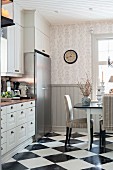 Dining set on chequered floor in rustic kitchen