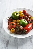 Various different coloured tomatoes on the white plate