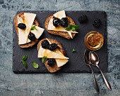 Bruschetta topped with cheese and blackberries