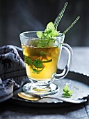 Peppermint tea with sprigs of fresh peppermint