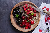 Various summer fruits in a wooden bowl