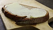 A slice of rye bread spread with butter