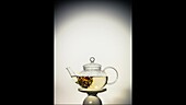 Tea with flowering tea in a glass jug