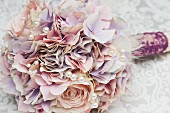 Bridal bouquet of pastel silk flowers with artificial pearls