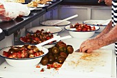 Tomato salad being made in a restaurant kitchen