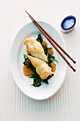 Fried rice rolls on leafy greens (Asia)