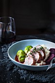 Pork fillet with a red wine vinegar sauce served with Brussels sprouts and mashed potatoes
