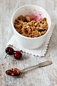 A bowl of apple and cherry crumble