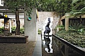 Rectangular pond and artworks in architectural garden