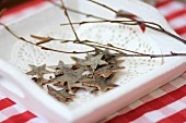 Star decorations made from bark on wooden tray