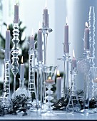 Atmospheric Christmas arrangement of many glass candlesticks